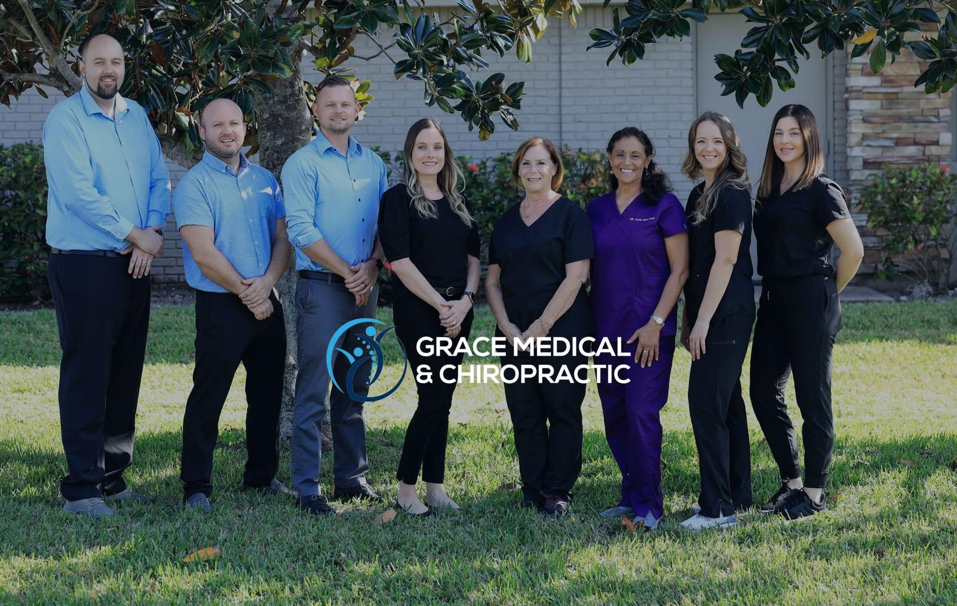Healthcare practice team standing together outside their clinic